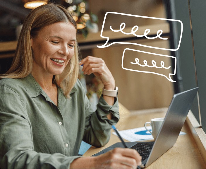 Woman smiling while using laptop with animated speech bubbles indicating online conversation or chat