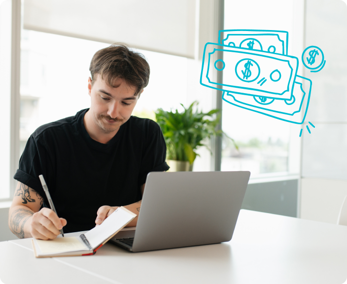 Man writing in notebook while using laptop with illustrated dollar bills and coins floating nearby