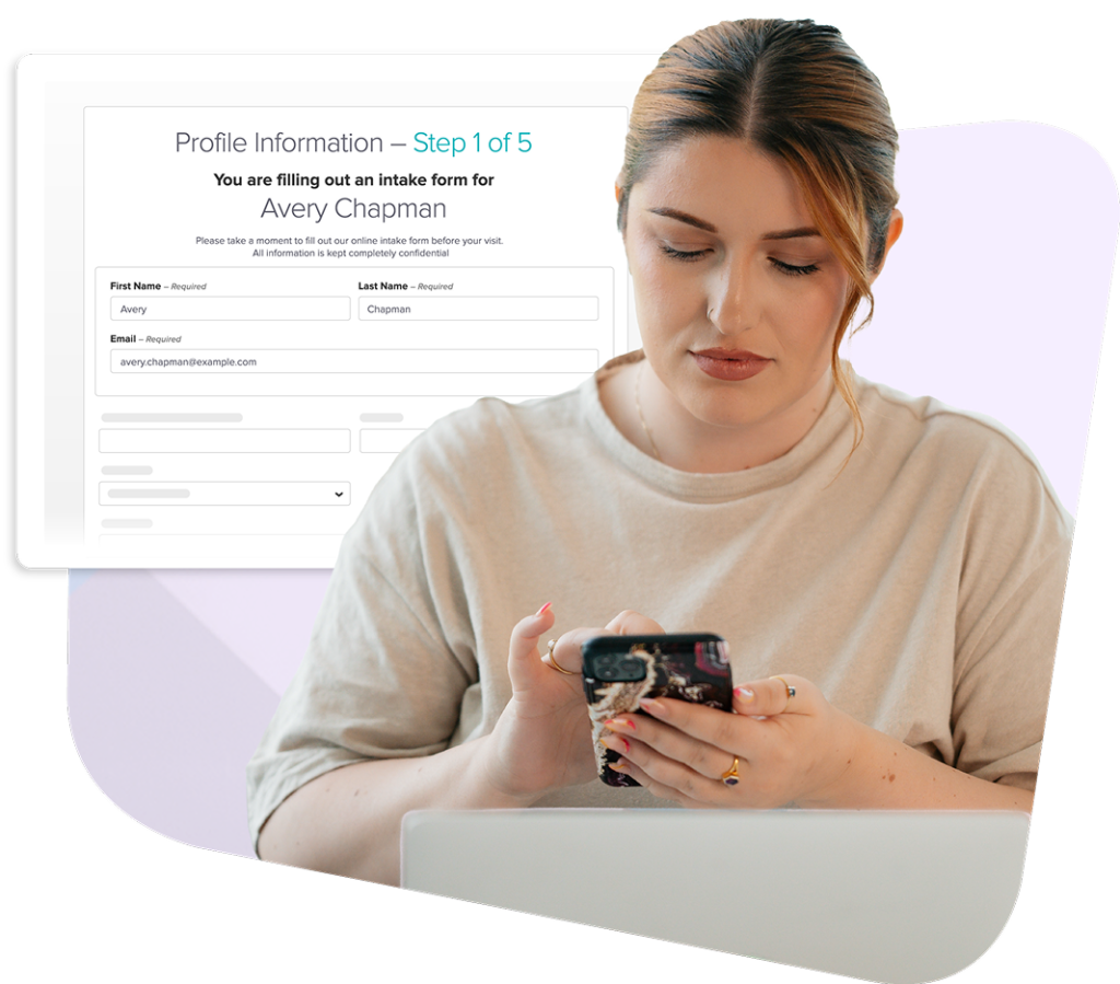 Woman using smartphone while sitting at laptop with intake form displayed on screen