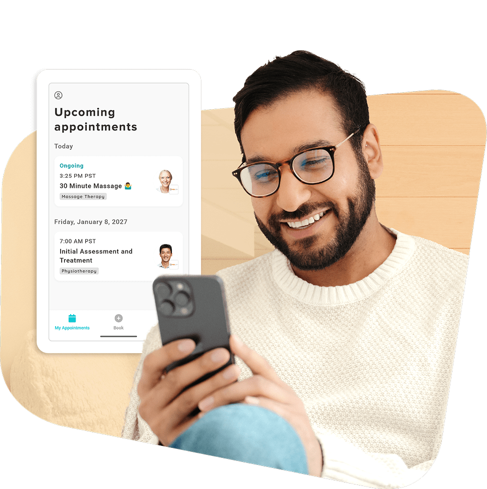 Man with glasses and beard smiling while looking at smartphone, with appointment scheduling interface showing upcoming massage therapy and physiotherapy sessions