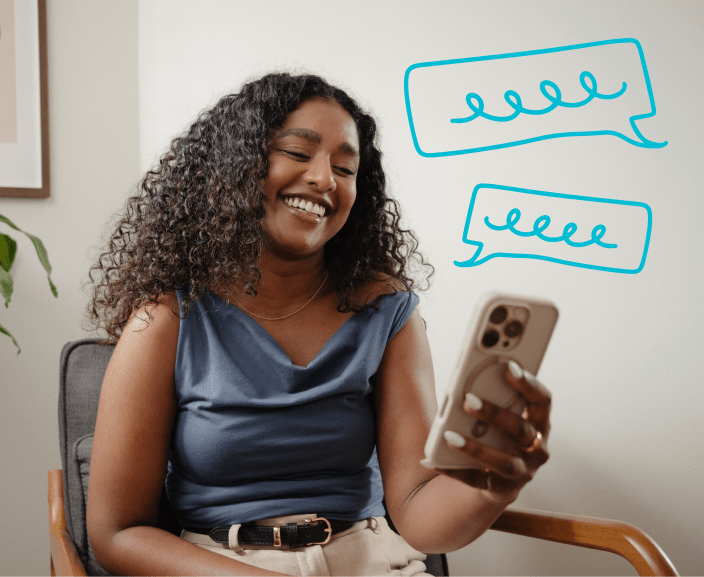 Woman smiling while looking at her phone with speech bubbles indicating a text conversation