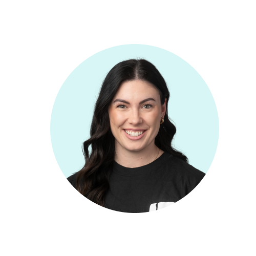 Professional headshot of a smiling woman with long dark hair wearing a black top