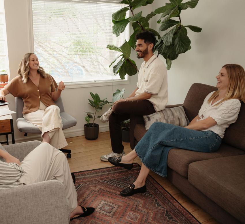 People chatting and laughing together in a relaxed living room setting